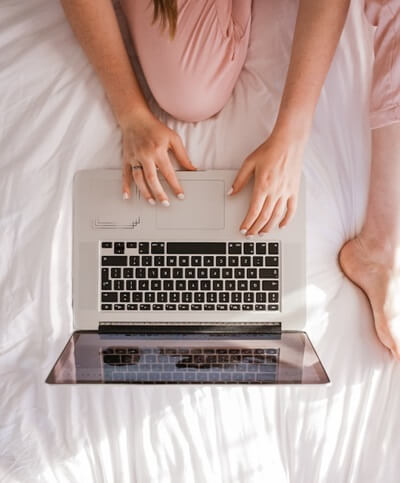 Person working on laptop with coffee